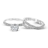 This impressive contemporary white gold engagement ring and wedding band set are emphasized by 1.00 ctw of dazzling round cut white diamonds.