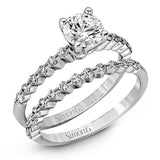 Featuring a charming classic design, this white gold engagement set is accented by .48 ctw of glistening round cut white diamonds.