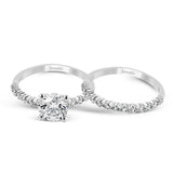 Featuring a charming classic design, this white gold engagement set is accented by .48 ctw of glistening round cut white diamonds.