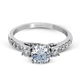 This classic three-stone engagement ring features .24 ctw of round brilliant side stones and .23 ctw of white diamonds extending down the sides.