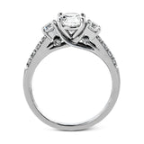 This classic three-stone engagement ring features .24 ctw of round brilliant side stones and .23 ctw of white diamonds extending down the sides.