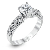Featuring a delicate floral design, this white gold vintage engagement ring is set with .35 ctw of shimmering white diamonds.