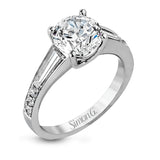 Contemporary in its design, this white gold engagement ring features .17 ctw of round cut white diamonds highlighted by .50 ctw of tapered baguette cut side diamonds.