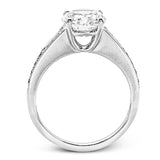 Contemporary in its design, this white gold engagement ring features .17 ctw of round cut white diamonds highlighted by .50 ctw of tapered baguette cut side diamonds.