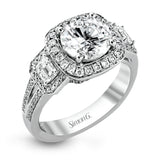 The dazzling contemporary design of this white gold engagement ring is emphasized by .44 ctw round cut white diamonds and .45 ctw emerald cut white diamonds.