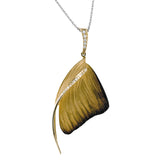 A delicate swirl of .13 ctw white diamonds highlights this contemporary pendant, featuring an eye-catching wood-grain design and suspended from a diamond-encrusted bail.