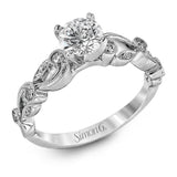 This delicate floral inspired white gold engagement ring and wedding band set is accentuated with .28 ctw shimmering round cut white diamonds.