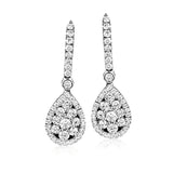 The dazzling teardrop design of these exquisite white gold earrings are accented by 1.07 ctw of round white diamonds, creating a memorable look.