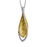 A modern leaf design pendant in 18K yellow gold suspended in a line of white diamonds 0.32 ctw, 19 adjustable chain