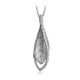 A modern leaf design pendant in 18K yellow gold suspended in a line of white diamonds 0.32 ctw, 19 adjustable chain