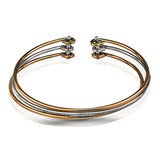 Reflecting an eye-catching but simple contemporary design, this three-tone open-style bangle bracelet is accentuated by .22 ctw of white diamonds.
