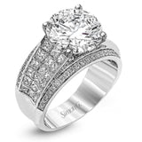 Presenting an eye-catching contemporary design, this white gold engagement ring features 1.31 ctw of princess cut white diamonds accented by .21 ctw of round cut white diamonds.