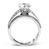 Presenting an eye-catching contemporary design, this white gold engagement ring features 1.31 ctw of princess cut white diamonds accented by .21 ctw of round cut white diamonds.