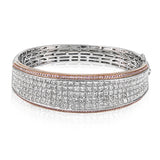 This Simon Set bracelet is the ultimate luxury statement with an astounding 13.64 ctw of white princess cut diamonds in its midst, accented by edges of .75 ctw of pink diamonds in rose gold.