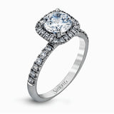 This elegant classic white gold halo engagement ring and band is set with .78 ctw of sparkling round cut white diamonds.