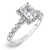 Featuring a delicate contemporary design, this brilliant white gold engagement ring is highlighted by .64 ctw of round cut white diamonds in an eye-catching geometric setting.