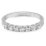 Elegantly simple, this classically styled white gold band is accented by the presence of .50 ctw of shimmering round cut white diamonds.