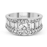 This eye-catching contemporary white gold engagement ring is accented by .75 ctw round cut white diamonds and 1.26 ctw baguette white diamonds for an unforgettable look.