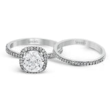 Featuring a contemporary take on a vintage style, this white gold engagement ring and band is complemented by .50 ctw of striking round cut white diamonds.