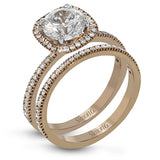 Featuring a contemporary take on a vintage style, this white gold engagement ring and band is complemented by .50 ctw of striking round cut white diamonds.