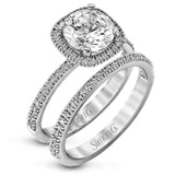 Featuring a contemporary take on a vintage style, this white gold engagement ring and band is complemented by .50 ctw of striking round cut white diamonds.