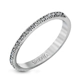 Accented by .46 ctw of glistening round cut white diamonds, this contemporary white gold halo style engagement ring and wedding band set makes a dramatic statement.