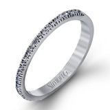 Accented by .46 ctw of glistening round cut white diamonds, this contemporary white gold halo style engagement ring and wedding band set makes a dramatic statement.