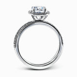 Accented by .46 ctw of glistening round cut white diamonds, this contemporary white gold halo style engagement ring and wedding band set makes a dramatic statement.