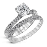 The classic design of this white gold engagement ring and wedding band set is emphasized by .72 ctw round cut white diamonds.