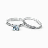 The classic design of this white gold engagement ring and wedding band set is emphasized by .72 ctw round cut white diamonds.