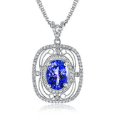 Featuring a vintage-inspired lacy design, this brilliant white gold pendant is set with a gorgeous 4.25 ctw oval cut tanzanite and .50 ctw round cut white diamonds.