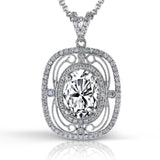 Featuring a vintage-inspired lacy design, this brilliant white gold pendant is set with a gorgeous 4.25 ctw oval cut tanzanite and .50 ctw round cut white diamonds.
