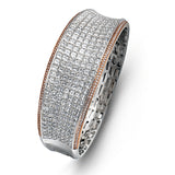 Offering a distinctive contemporary style, this bangle bracelet is white and rose gold is accented by an astounding 18.85 ctw princess cut white diamonds and .79 round pink diamonds.