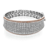 Offering a distinctive contemporary style, this bangle bracelet is white and rose gold is accented by an astounding 18.85 ctw princess cut white diamonds and .79 round pink diamonds.