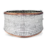 Offering a distinctive contemporary style, this bangle bracelet is white and rose gold is accented by an astounding 18.85 ctw princess cut white diamonds and .79 round pink diamonds.