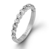 This marvelous white gold wedding set highlights its center stone with 1.19 ctw of round white diamond accents.