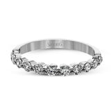 This marvelous white gold wedding set highlights its center stone with 1.19 ctw of round white diamond accents.
