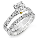 This charming contemporary two-tone wedding set is accented by .66 ctw of glistening round cut white diamonds with .02 ctw round cut yellow diamond accents.