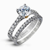 This charming contemporary two-tone wedding set is accented by .66 ctw of glistening round cut white diamonds with .02 ctw round cut yellow diamond accents.