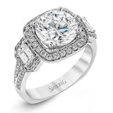 Featuring an impressive modern design, this white gold ring features .53 ctw emerald cut stone sides and .46 ctw round cut white diamonds.