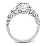 This white gold engagement ring's sophisticated, contemporary design glitters with 1.14 ctw of round white diamonds flanking the center stone.