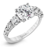 This white gold engagement ring's sophisticated, contemporary design glitters with 1.14 ctw of round white diamonds flanking the center stone.