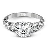 This white gold engagement ring's sophisticated, contemporary design glitters with 1.14 ctw of round white diamonds flanking the center stone.