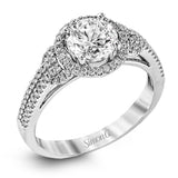 This 18k white gold ring contains .30 ctw of side diamonds set within its classic halo design.
