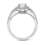This 18k white gold ring contains .30 ctw of side diamonds set within its classic halo design.
