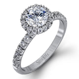 The classic halo design of this white gold engagement ring and wedding band are elevated by .80 ctw of shimmering round cut white diamonds.