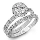 The classic halo design of this white gold engagement ring and wedding band are elevated by .80 ctw of shimmering round cut white diamonds.