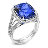 This classic 18k white gold ring features an extraordinary 14.25 ct tanzanite center stone which is accented by .89 ctw of white diamonds.