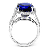 This classic 18k white gold ring features an extraordinary 14.25 ct tanzanite center stone which is accented by .89 ctw of white diamonds.