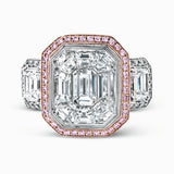 This impressive white and rose gold ring is set with a 3.0 ctw mosaic of white diamonds accented by .45 ctw round cut white diamonds, 1.06 emerald cut white diamonds, and .30 pink diamonds.